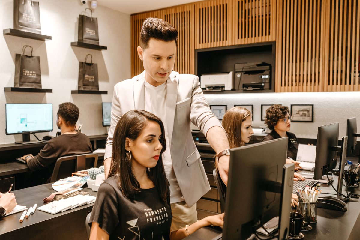 A technician helping a user at their desktop